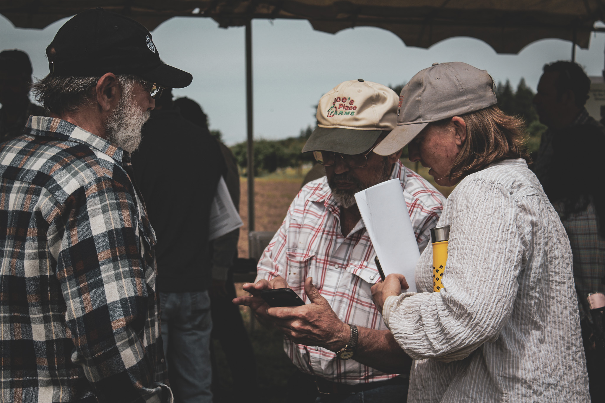 PNW growers reviewing research data in the field